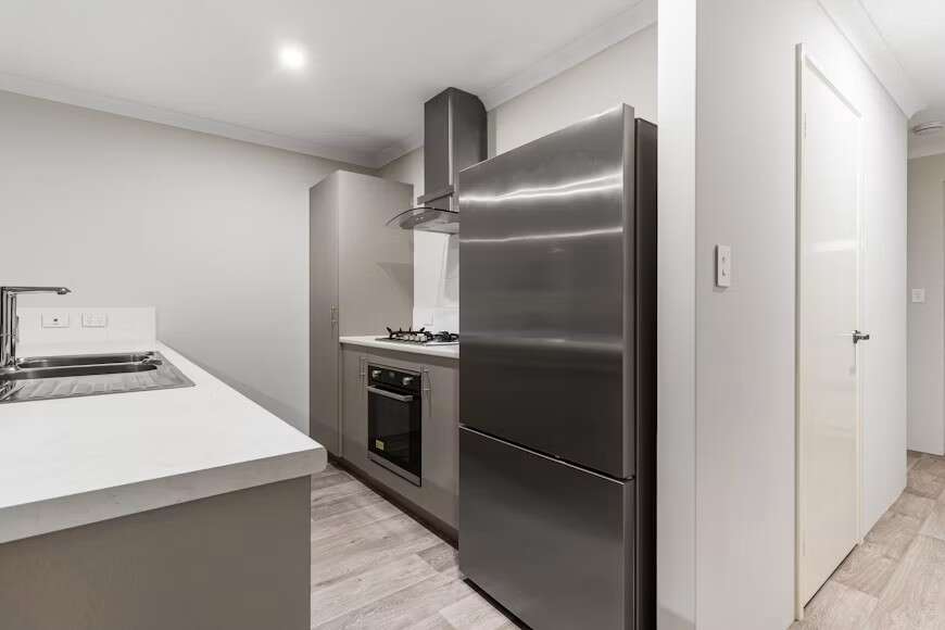 A Kitchen With A Refrigerator And A Stove Top Oven LS VhuiWUno